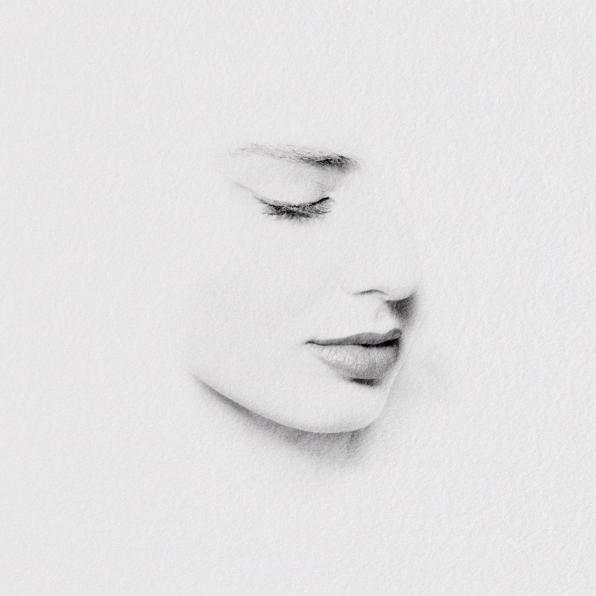 A partially revealed pencil portrait sketch